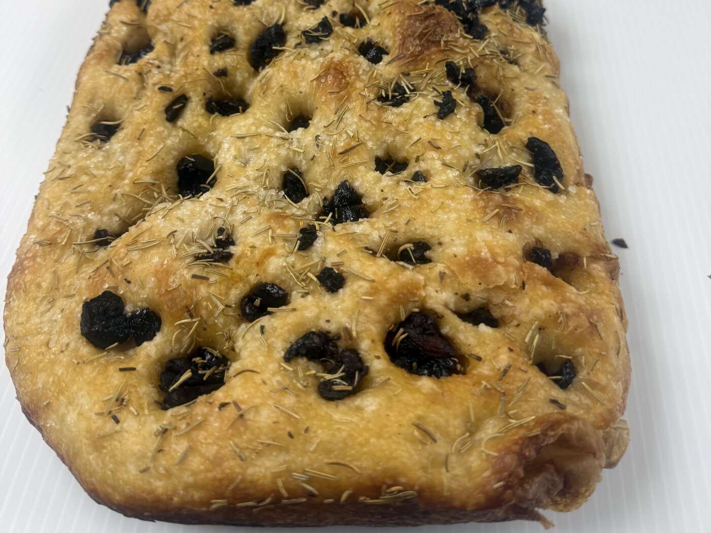 Nana’s sourdough focaccia loaf with black olives, sun-dried tomatoes, rosemary and sea salt